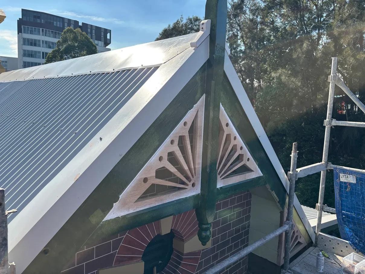 Decorative gable fretwork restoration on a heritage brick station building