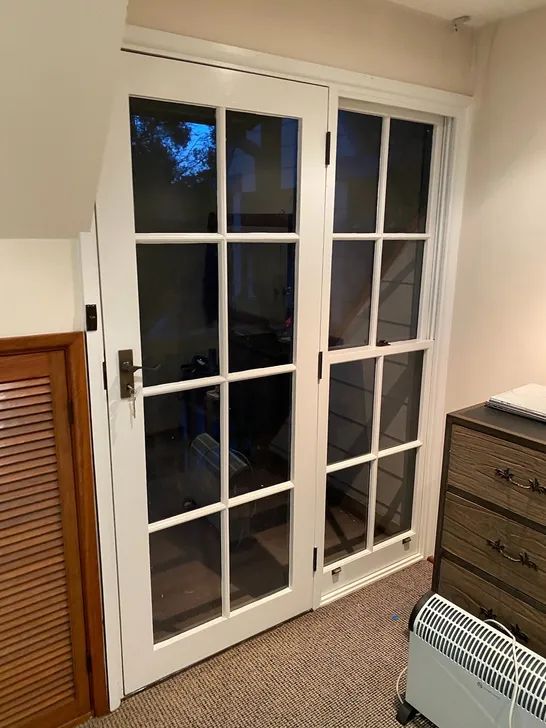 White French doors with multi-pane glazing in a period interior