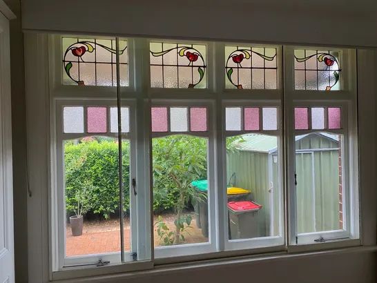 Art Nouveau stained glass flower motif in a multi-pane window