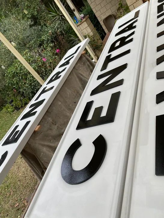 Original metal letters and timber backboard during Central Station sign restoration